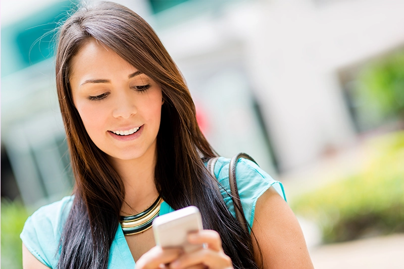 women on her phone looking for answers because she is struggling to get pregnant despite trying multiple ovulation trackers and using online fertility help